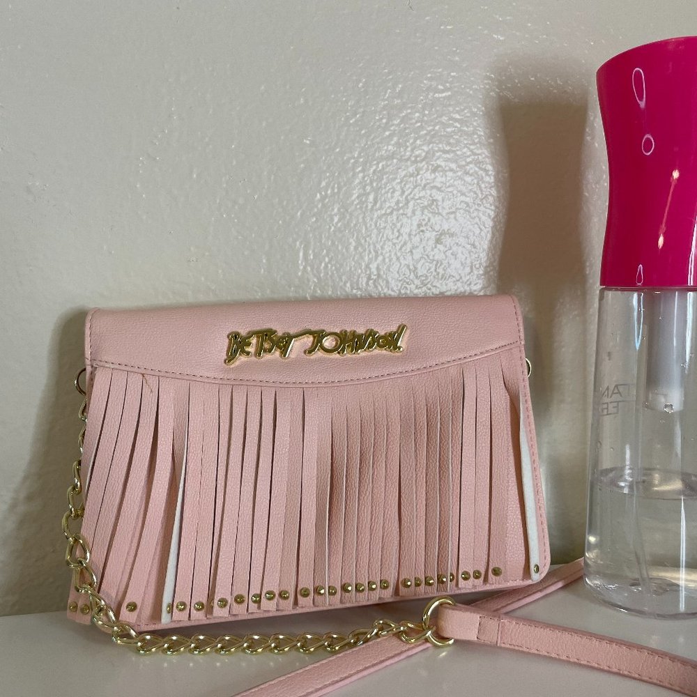 Pink Betsey Johnson wallet on a strap